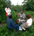 This shows Elliud Muli and Maryann Frazier interviewing Kenyan beekeepers, south of Mombasa, Kenya.
