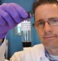 Jacob D. Lanphere, a Ph.D. student at UC Riverside, holds a sample of graphene oxide.