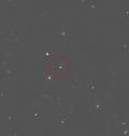 The runaway star cluster HVGC-1 (circled) in a photo from the Canada-France-Hawaii Telescope. The cluster is zooming toward us at a speed of more than two million miles per hour.
