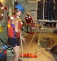 Kelsey Poulson-Ellestad, a former graduate student at the Georgia Institute of Technology, now at Woods Hole Oceanographic Institution, works with a Conductivity, temperature and depth (CTD) sampling rosette, which is lowered over the side of a vessel and is used to
collect water samples from various depths.