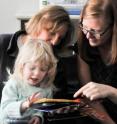 Graduate student Abigale Stangl (right), a CU-Boulder doctoral student and a volunteer at the Anchor Center for Blind Children in Denver, shows Isabella Chinkes and her mother, Linda, a 3D version of 'Goodnight Moon.'