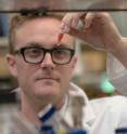 Andrew King, a chemical biology graduate student at McMaster University examines a chemical used in drug discovery research.