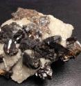 A team of ASU researchers has demonstrated that a particular mineral, sphalerite, can affect the most fundamental process in organic chemistry: carbon-hydrogen bond breaking and making. This is a sample of gem-quality sphalerite in a quartz matrix.