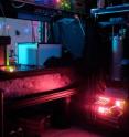 This image shows the University of Waterloo laboratory where scientists entangled three photons. NIST's single-photon detectors were chilled to near absolute zero in the refrigerator (large blue cylinder). The experiment had to be performed in the dark because of the need to detect very low light levels.