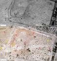 Between Oct. 10, 2009, (top) and March 8, 2014, (bottom), Palmyra's North Roman Necropolis has been disrupted by road construction and numerous earthen berms (pink arrows) to provide cover for military vehicles (yellow arrows).