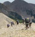A group of backpackers hike on an Outward Bound course in the La Sal Mountains, UT.