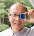 NTU professor Sun Xiaowei holds his smart window invention that can self-tint and also functions as a battery.