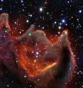 Like the gaping mouth of a gigantic celestial creature, the cometary globule CG4 glows menacingly in this image from ESO's Very Large Telescope. Although it looks huge and bright in this image it is actually a faint nebula and not easy to observe. The exact nature of CG4 remains a mystery.