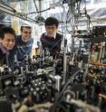 University of Chicago scientists can create an exotic, particle-like excitation called a roton in superfluids with the tabletop apparatus pictured here. Posing from left are graduate students Li-Chung Ha and Logan Clark, and physics Professor Cheng Chin.