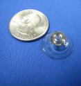 This is the latest version of the telescopic contact lens, with a quarter for scale.