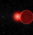 This is an artist's conception of Scholz's star and its brown dwarf companion (foreground) during its flyby of the solar system 70,000 years ago. The Sun (left, background) would have appeared as a brilliant star. The pair is now about 20 light years away.
