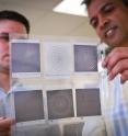 University of Utah graduate student Andrew Paulsen, left, and U electrical and computer engineering professor Ajay Nahata hold up a series of terahertz frequency filters made through a process they developed with an inkjet printer. They have discovered a new approach for designing filters capable of separating different frequencies in the terahertz spectrum, the next generation of communications bandwidth that could allow cell-phone users and Internet surfers to download data a thousand times faster than today.