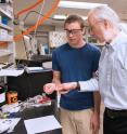 Dan Buttry, professor and chair of ASU's Department of Chemistry and Biochemistry, examines a battery sample with graduate student Tylan Watkins.