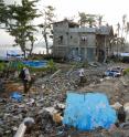 Typhoon Haiyan was the strongest hurricane ever recorded to make landfall. Working with villagers, the researchers sampled wells among the debris and destruction. Professor Phil Bennett is walking over the ruins of a concrete house