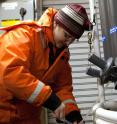 University of Alaska researcher Jessica Cross tests water samples during Arctic research cruise on USCG cutter Healy.