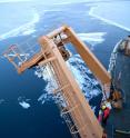 The crew lowers sensors that measure water temperature, salinity and dissolved carbon in the Arctic Ocean.