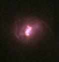 A Hubble Space Telescope color image of one of the nine galaxies targeted by NuSTAR. The high-energy X-rays detected by NuSTAR revealed the presence of an extremely active supermassive black hole at the galaxy center, deeply buried under a blanket of gas and dust.