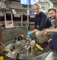 Doug Abernathy, left, ARCS instrument scientist at Oak Ridge National Laboratory, and Marc Janoschek, Los Alamos National Laboratory, prepare their sample for experiments at the Spallation Neutron Source.