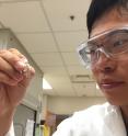 Georgia Tech graduate student Sheng-Sheng Yu holds a sample that has been subjected to repeated cycles of wet-dry conditions. From amino acids and hydroxy acids, the process results in a mixture of polyesters and peptides containing as many as 14 units.