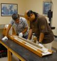 Ali Pourmand (left) and Ph.D. candidate Arash Sharifi visually inspect the physical properties of a sediment core collected from NW Iran. This meter-long core recorded the environmental condition of the region for the past 2000 years.