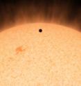 This artist's conception shows the silhouette of a rocky planet, dubbed HD 219134b, as it passes in front of its star. At 21 light-years away, the planet is the closest outside of our solar system that crosses, or transits, its star -- a bonus for astronomers because transiting planets are easier to study. The planet, which is about 1.6 times the size of Earth, is also the nearest confirmed rocky planet outside our solar system. It orbits a star that is cooler and smaller than our sun, whipping snuggly around it in a mere 3 days. The proximity of the planet to the star means that it would be scorching hot and not habitable.