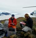 Researchers work with seismic equipment to track meltwater running through Alaska's Yahtse Glacier.