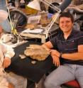 Fossil preparator Jerry Golden and doctoral student Joshua Lively display the 76-million-year-old turtle fossil Arvinachelys golden.