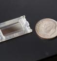 Nanoparticle removal chip next to a dime for comparison.