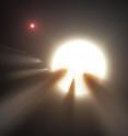 This illustration shows a star behind a shattered comet. Observations of the star KIC 8462852 by NASA's Kepler and Spitzer space telescopes suggest that its unusual light signals are likely from dusty comet fragments, which blocked the light of the star as they passed in front of it in 2011 and 2013. The comets are thought to be traveling around the star in a very long, eccentric orbit.