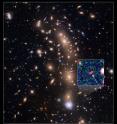 This is a Hubble Space Telescope view of a very massive cluster of galaxies, MACS J0416.1-2403, located roughly 4 billion light-years away and weighing as much as a million billion suns. The inset is an image of an extremely faint and distant galaxy that existed only 400 million years after the big bang. Hubble captured it because the gravitational lens makes the galaxy appear 20 times brighter than normal.