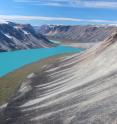 In western Greenland, small outlet glaciers are wasting backward, leaving behind piles of rocks, or moraines, that mark their previous advances. Meltwater has formed a lake.