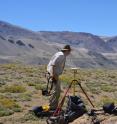 Basil Tikoff, professor of geoscience at UW-Madison, uses a precise GPS instrument to record shoreline altitude at Laguna del Maule.