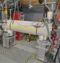 Brookhaven Lab accelerator physicist Wolfram Fischer stands next to the electron lensing apparatus at the Relativistic Heavy Ion Collider (RHIC), a particle accelerator/collider at the US Department of Energy's Brookhaven National Laboratory.