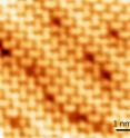 Atomic size defects on the surface of a perovskite crystal.