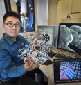 Brookhaven Lab physicist Huolin Xin is in front of an aberration-corrected scanning transmission electron microscope at the Center for Functional Nanomaterials.