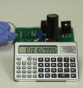 With this triboelectric nanogenerator and two-stage power management and storage system, finger tapping motion generates enough power to operate this scientific calculator.