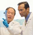 Arul Chinnaiyan, right, consults with one of his lab associates.