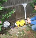 Stephen Decina, Boston University PhD student, measures carbon dioxide being released from the soil using an automated soil carbon dioxide efflux system. The equipment, which is controlled with a smartphone, passes air through an infrared gas analyzer and measures the concentration of carbon dioxide accumulation over time.