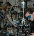 Erica Calman and Chelsey Dorow align optics required to collect measurements from a molybdenum disulfide sample.