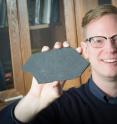 Stephen Dornbos, UWM associate professor of geosciences, holds one of the samples of ancient multicellular algae fossils he helped excavate in western Mongolia.