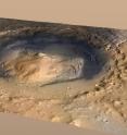 Gale Crater, the landing spot of the Mars rover Curiosity, has a three-mile-high mound at its center called Mount Sharp. The circle is the landing place of Curiosity. The blue line is its path.