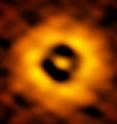 This is the inner region of the TW Hydrae protoplanetary disk as imaged by ALMA. The image has a resolution of 1 AU (Astronomical Unit, the distance from the Earth to the Sun in our own Solar System). This new ALMA image reveals a gap in the disk at 1 AU, suggesting that a planet with the same orbit as Earth is forming there.