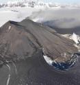 Aerial view of the active vent, erupting intracaldera cone, and new lava flows at Veniaminof Volcano in August 2013.