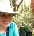 Wright holds a nestling Whitehead's broadbill in Borneo, where she now conducts fieldwork studying the biomechanics of how birds learn to fly.