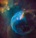 This is a Hubble Space Telescope photograph of an enormous, balloon-like bubble being blown into space by a super-hot, massive star. Astronomers trained the iconic telescope on this colorful feature, called the Bubble Nebula, or NGC 7635.