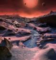 This artist's impression shows an imagined view from the surface one of the three planets orbiting an ultracool dwarf star just 40 light-years from Earth that were discovered using the TRAPPIST telescope at ESO's La Silla Observatory. These worlds have sizes and temperatures similar to those of Venus and Earth and are the best targets found so far for the search for life outside the solar system. They are the first planets ever discovered around such a tiny and dim star.
<P>
In this view one of the inner planets is seen in transit across the disc of its tiny and dim parent star.