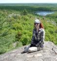 First author Edel O'Sullivan enjoys the sunshine by the Sudbury Crater in Canada.