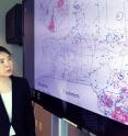 This photo shows Georgia Tech Ph.D. student Yun Wei and Associate Professor Chuanyi Ji with a map showing utility disruptions in New York State resulting from Super Storm Sandy.