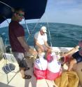 Study authors Jason Westrich, left, and Bill Landing, center, collect water with Neil Wyatt in the Florida Keys.