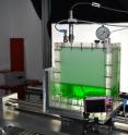 A Hiroshima University researcher traveled to the GFZ German Research Centre for Geosciences to collaborate on a project examining the connection between earthquakes and volcanic eruptions.  A sealed box of a syrupy liquid (dyed green) with a tall layer of foamy bubbles on top is connected to sensors and recording equipment.